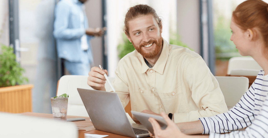 Man at desk reconciling accounts and reviewing revenue trends for end-of-year reporting