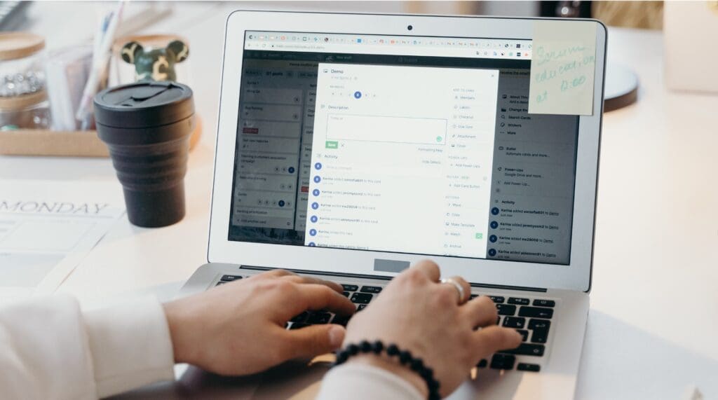 Small business owner using Asana on a laptop to manage tasks